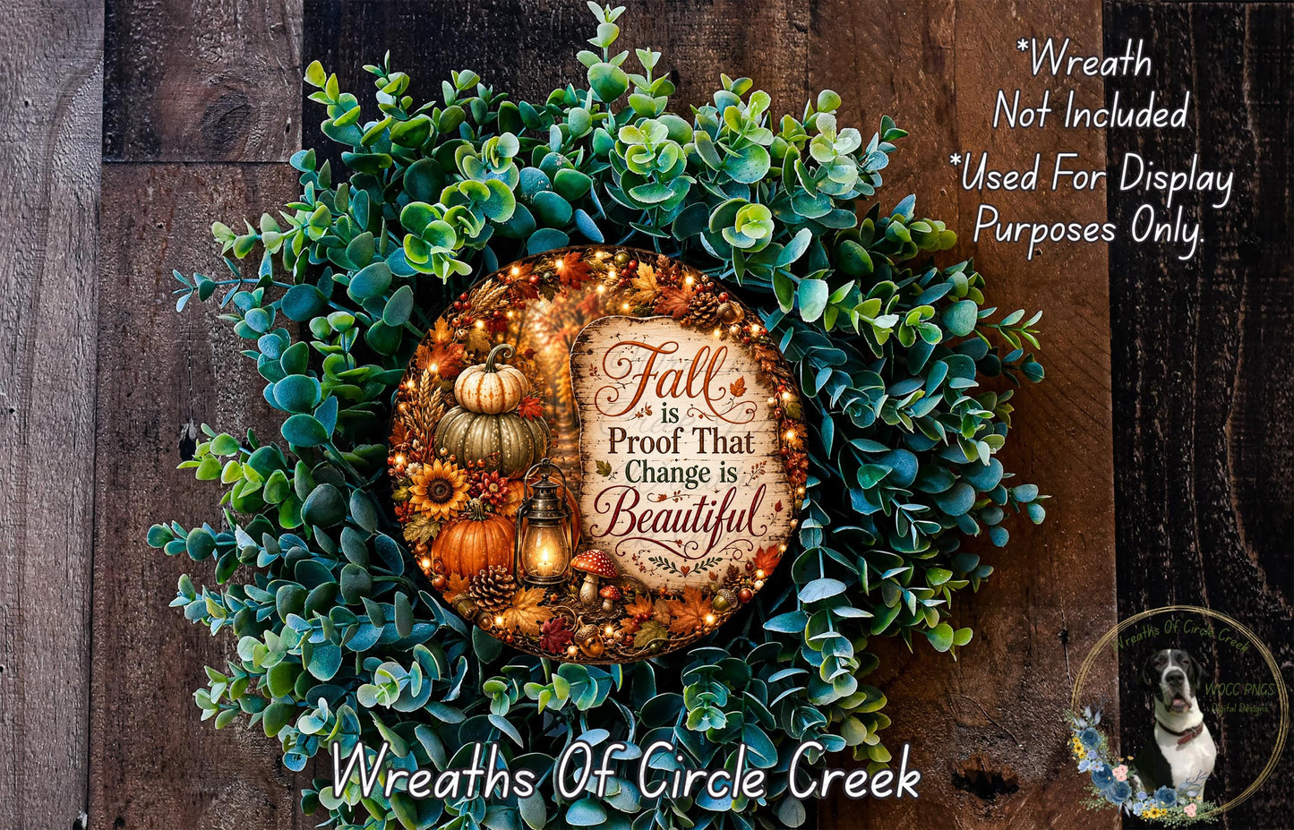 a wreath made of various fall-themed elements, including pumpkins, sunflowers, and pine cones, set against a wooden background. The wreath is adorned with a sign that reads "Fall is Proof That Change is Beautiful".