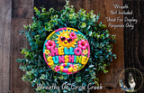 A colorful wreath made of green leaves and flowers, with a large "Hello Sunshine" sign in the center.