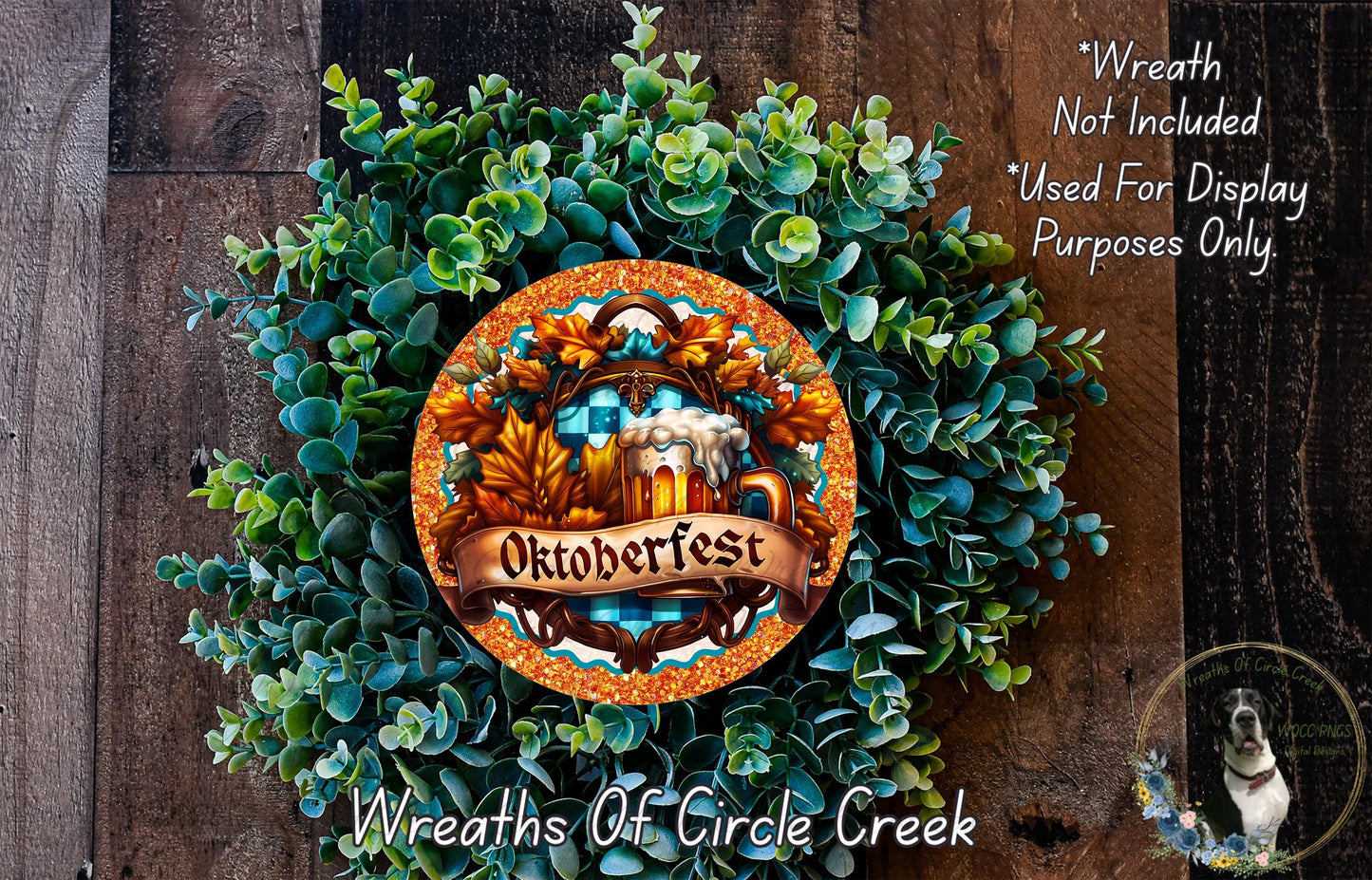 a wreath made of green leaves and a beer mug, with the word "Oktoberfest" written on it. The wreath is displayed on a wooden surface, and there is a small dog in the bottom right corner of the image.