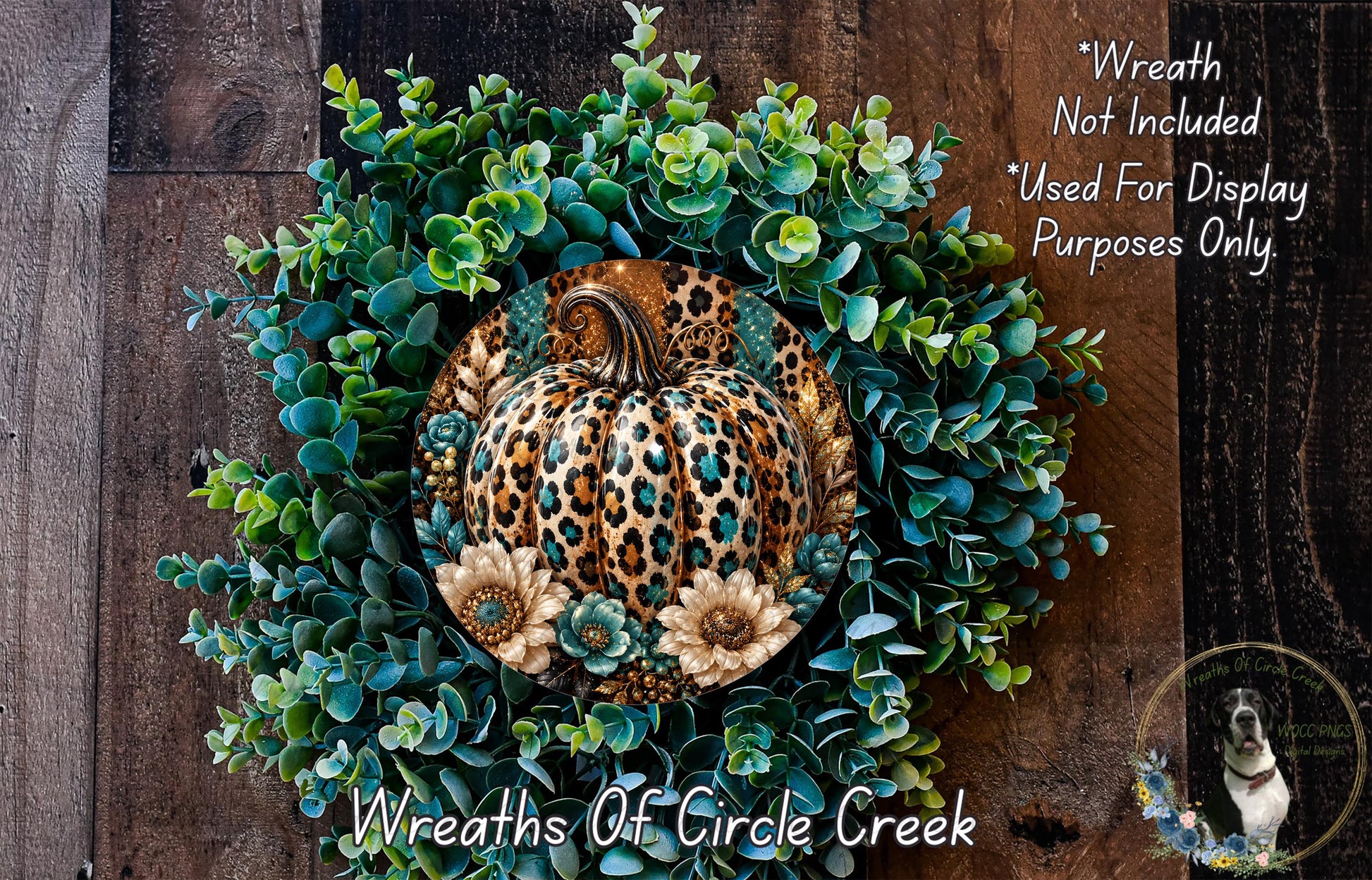 A wreath made of various green leaves and a leopard print pumpkin, with a dog in the background.