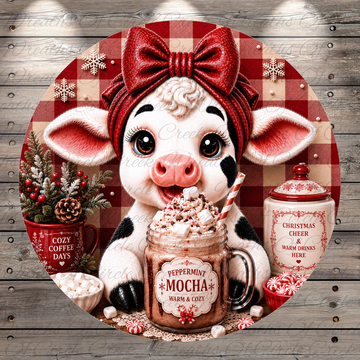 A whimsical image featuring a cow wearing a red bow and surrounded by holiday decorations, including a mug of peppermint mocha, a mug of warm and cozy, and a mug of Christmas cheer.