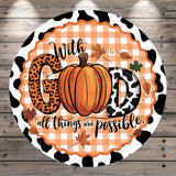A decorative round sign with a pumpkin and leopard print elements, surrounded by leaves and the text "With GOD all things are possible."