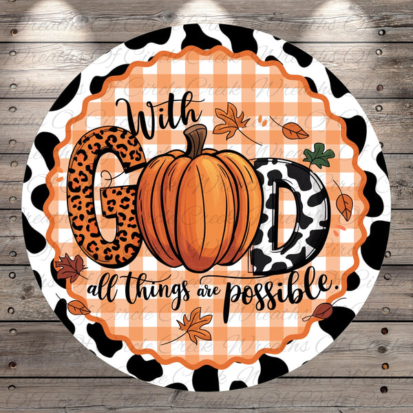 A decorative round sign with a pumpkin and leopard print elements, surrounded by leaves and the text "With GOD all things are possible."