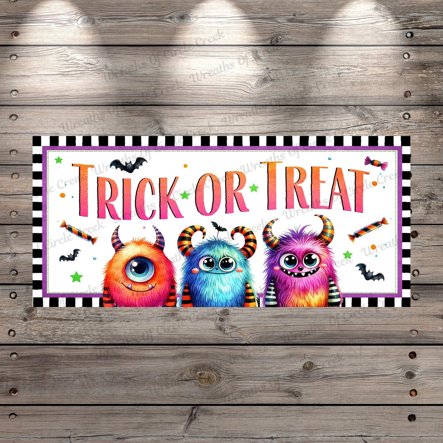a trick or treat sign hanging on a wooden wall