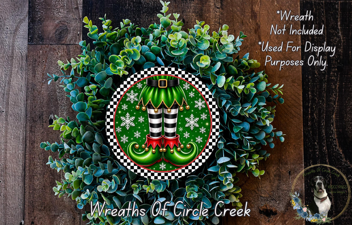 A wreath made of green leaves and white snowflakes, with a pair of green elf boots and red and gold shoes as the central design element.