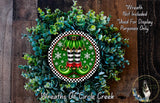A wreath made of green leaves and white snowflakes, with a pair of green elf boots and red and gold shoes as the central design element.