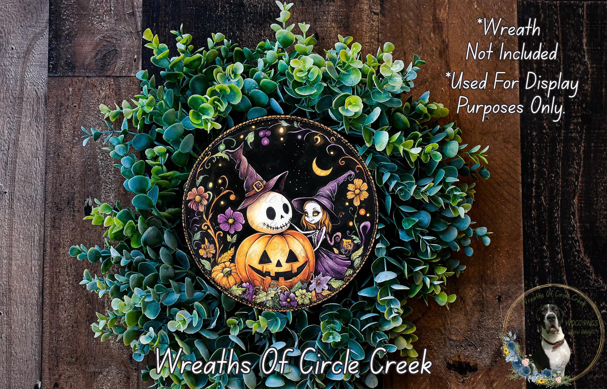 A Halloween-themed wreath made of green foliage and featuring a jack-o-lantern, a witch, and other spooky elements.