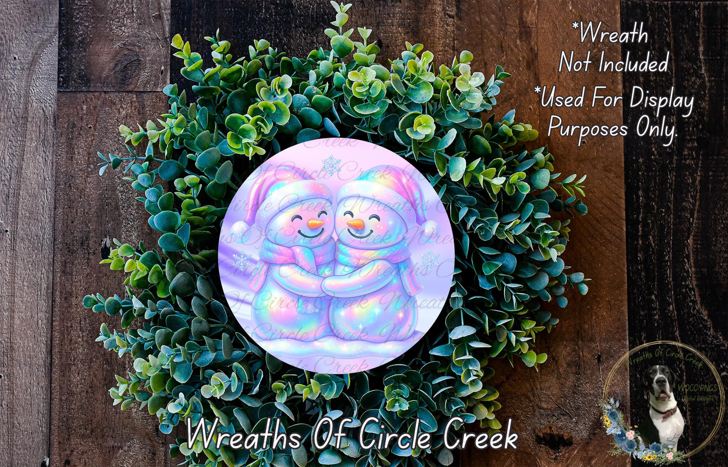 A wreath made of green plants and featuring two smiling snowmen.