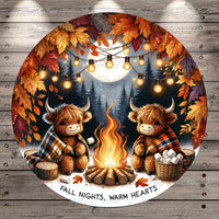 A cozy scene of two furry animals, possibly bison or cows, sitting around a campfire and enjoying the warmth and comfort of the fire. The background features a forest with autumn leaves, and string lights are strung up around the scene, creating a festive atmosphere. The text "FALL NIGHTS, WARM HEARTS" is displayed, suggesting a seasonal theme related to the fall season.