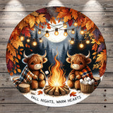 A cozy scene of two furry animals, possibly bison or cows, sitting around a campfire and enjoying the warmth and comfort of the fire. The background features a forest with autumn leaves, and string lights are strung up around the scene, creating a festive atmosphere. The text "FALL NIGHTS, WARM HEARTS" is displayed, suggesting a seasonal theme related to the fall season.