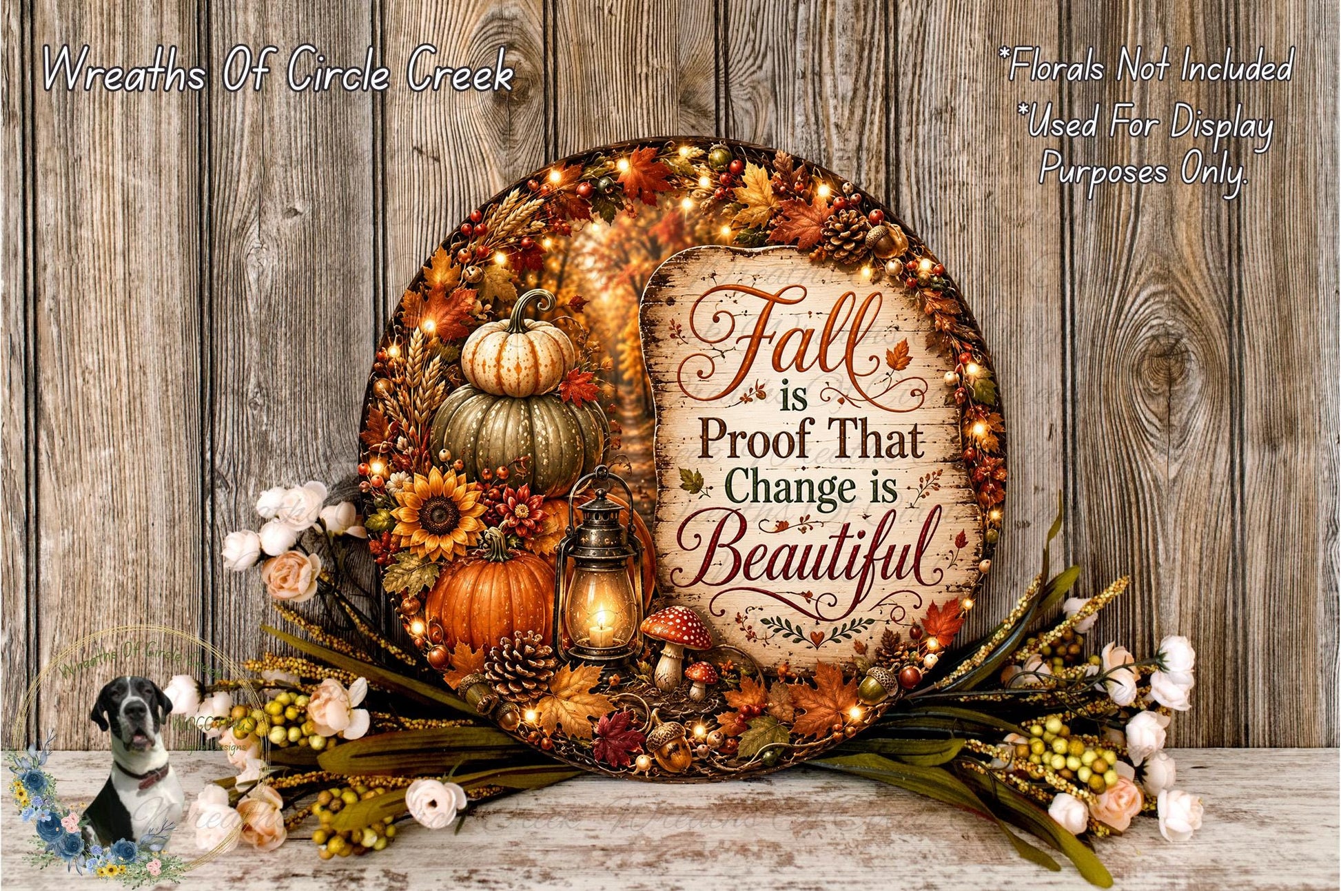 a decorative wreath with fall-themed elements, including pumpkins, sunflowers, pine cones, and a lantern, set against a rustic wooden background.