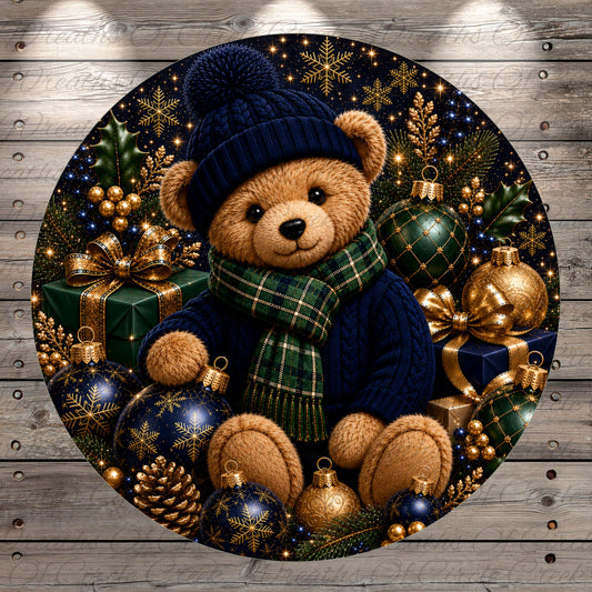 A teddy bear wearing a blue hat and scarf sits amidst a festive arrangement of Christmas ornaments, presents, and pine cones.