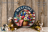a circular sign with a welcoming message, surrounded by a basket of flowers and a rustic wooden background.