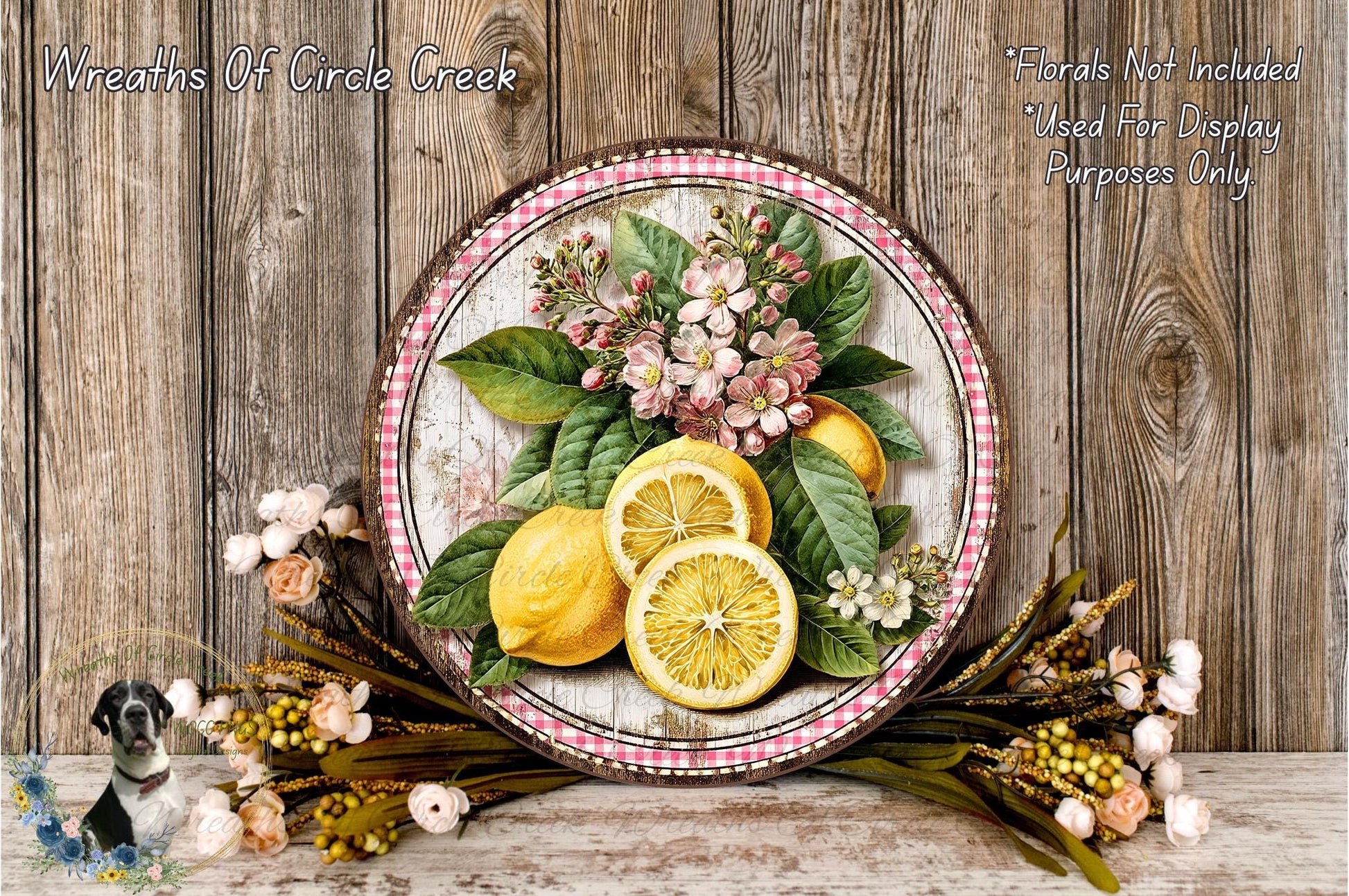 A decorative plate with a floral arrangement of lemons and flowers, placed on a wooden surface.