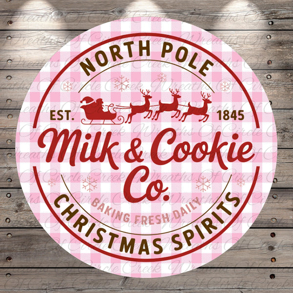 a circular logo for a company called "Milk & Cookie Co." with a Santa Claus sleigh and reindeer design. The logo is set against a pink and white checkered background.