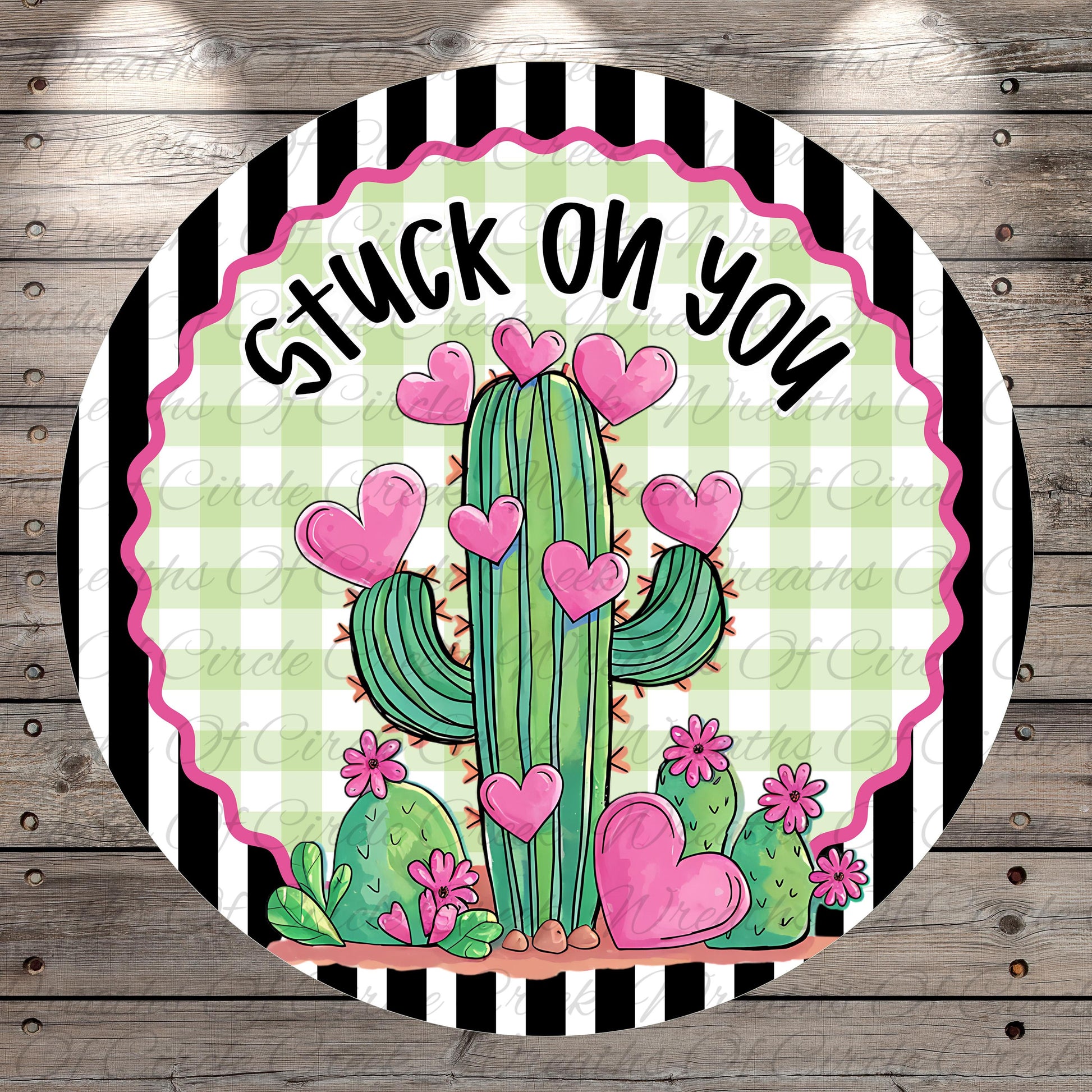 A round graphic with a cactus surrounded by pink hearts and flowers, with the text "Stuck on you" written above it.