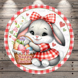 A cute cartoon rabbit holding a basket of Easter eggs, wearing a red and white checkered dress and a bow, with the text "Happy Easter" displayed on the basket.