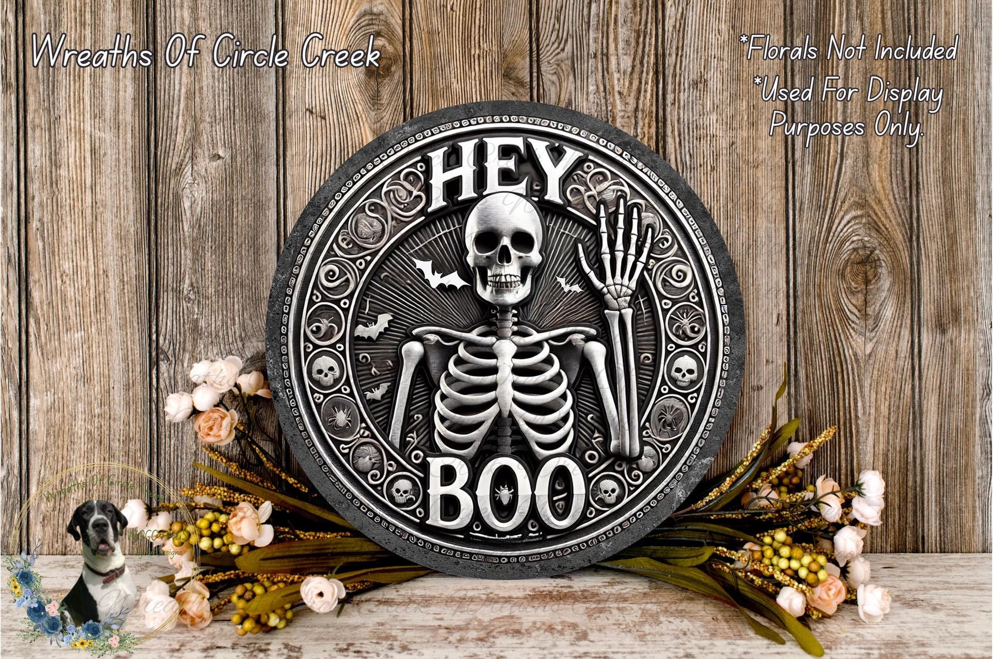 a metal plaque with a skeleton and bones on it