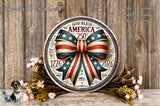 A circular wooden sign with a bow and the text "God Bless America 250th" is displayed on a wooden surface, surrounded by flowers and greenery.