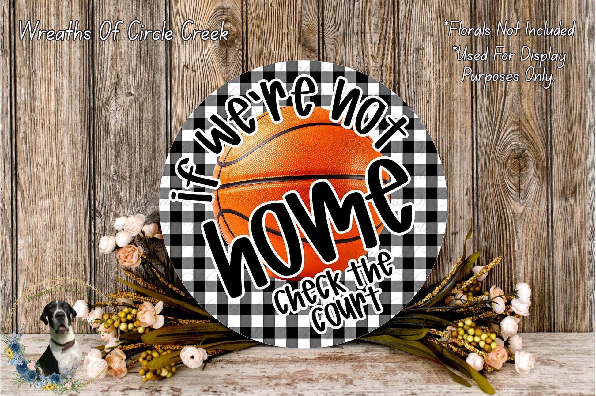 a basketball-themed sign with the text "If we're not home, check the court" displayed on it, surrounded by flowers and a wooden background.