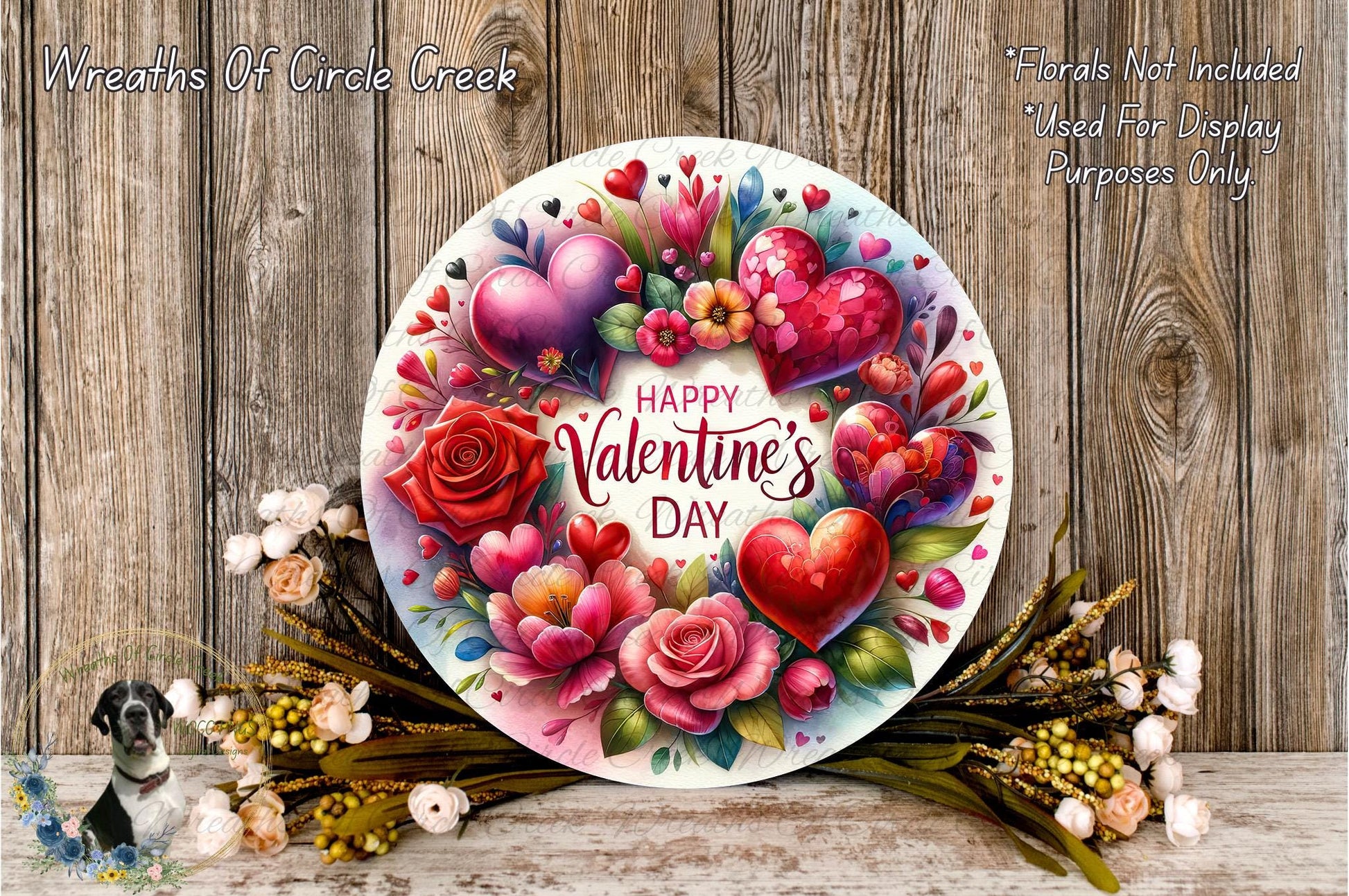 a round, decorative plate with a floral wreath design, surrounded by various flowers and greenery. The plate has a message that reads "Happy Valentine's Day".