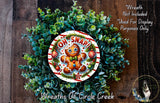 A wreath made of green plants and a gingerbread man figure with the text "OH! SNAP!" on it.