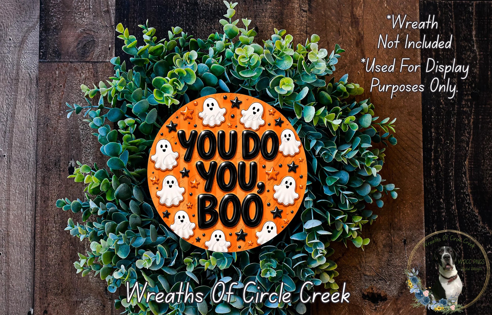 A Halloween-themed wreath made of green foliage and orange and white ghost decorations, with the text "YOU DO YOU BOO" displayed on the wreath.