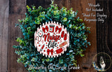 a wreath made of green leaves and flowers, with a decorative design that includes a red and white sign that says "Nurse life".