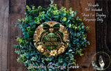 A wreath made of green and gold foliage, with a "Merry Christmas" sign in the center, and a dog in the bottom right corner.