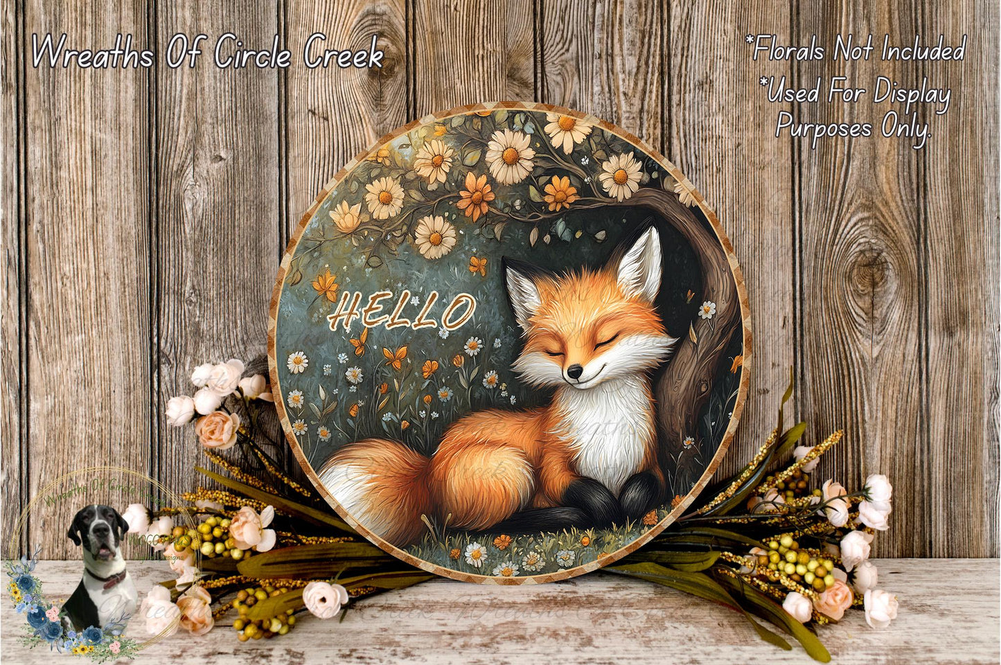 A round wooden plaque with a painting of a sleeping fox surrounded by flowers and greenery.