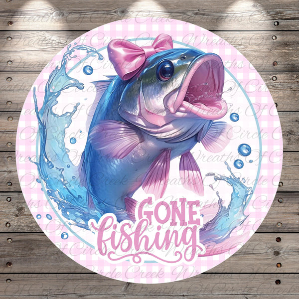 A round, pink and white graphic featuring a fish with a pink bow on its head, surrounded by splashing water and bubbles, with the text "GONE FISHING" prominently displayed.