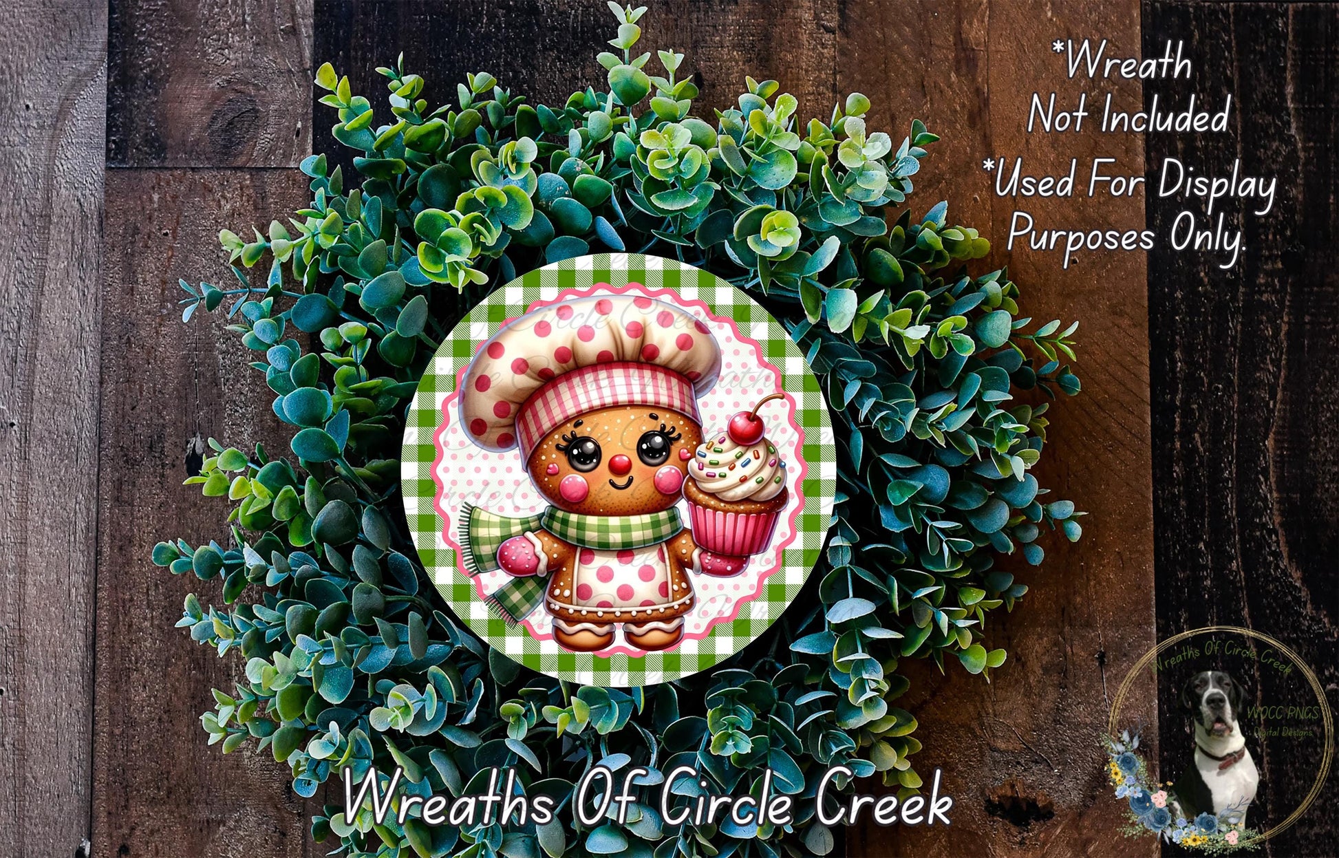 A wreath featuring a gingerbread man holding a cupcake, surrounded by a lush green plant.