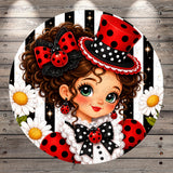 A whimsical illustration of a young girl with curly hair, wearing a top hat and a dress with red and black polka dots, surrounded by flowers and a wooden background.