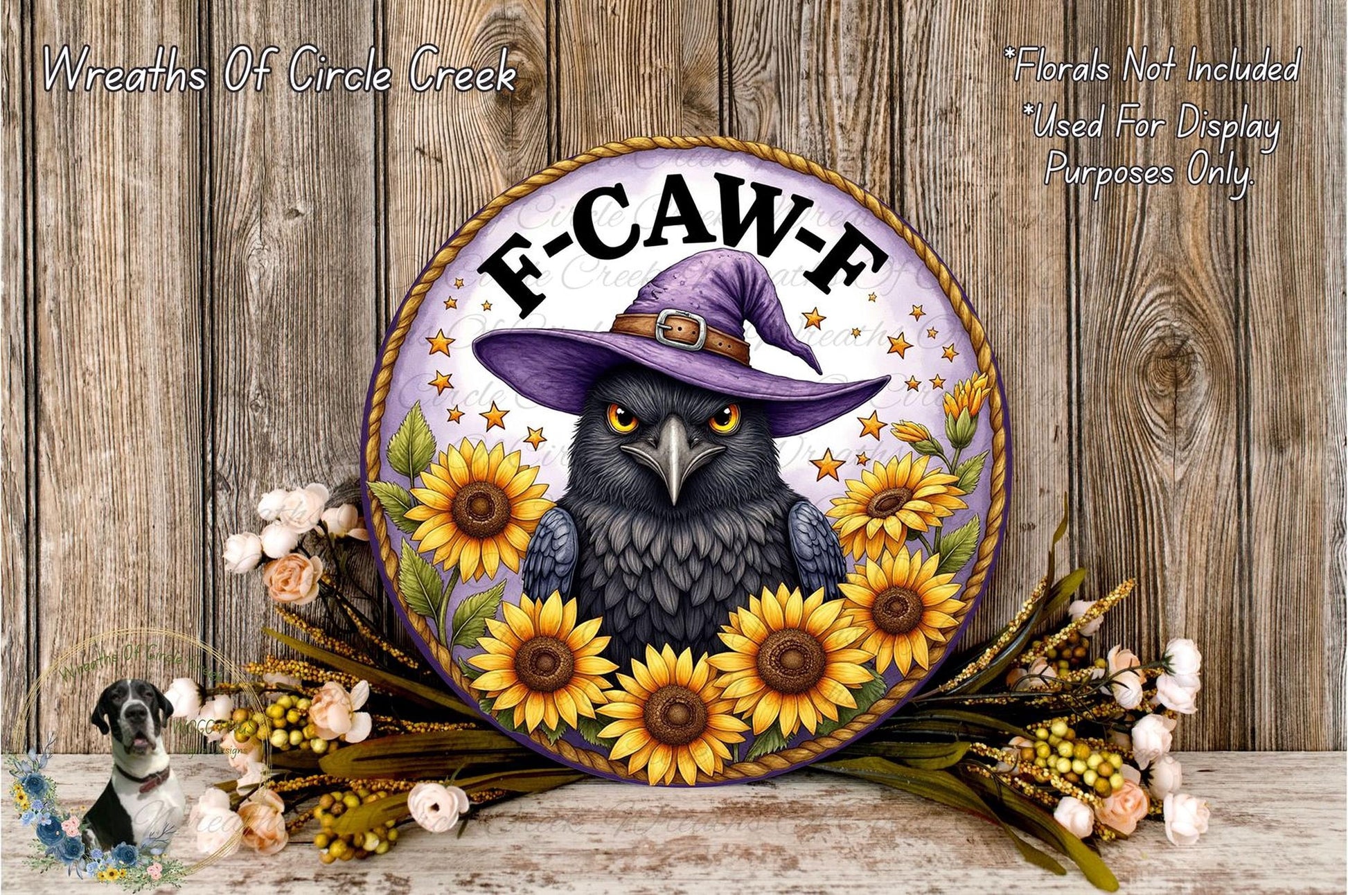 a decorative sign with a black bird wearing a purple witch's hat, surrounded by sunflowers and other flowers. The sign has a purple background with the text "F-CAW-F" and is placed on a wooden surface.