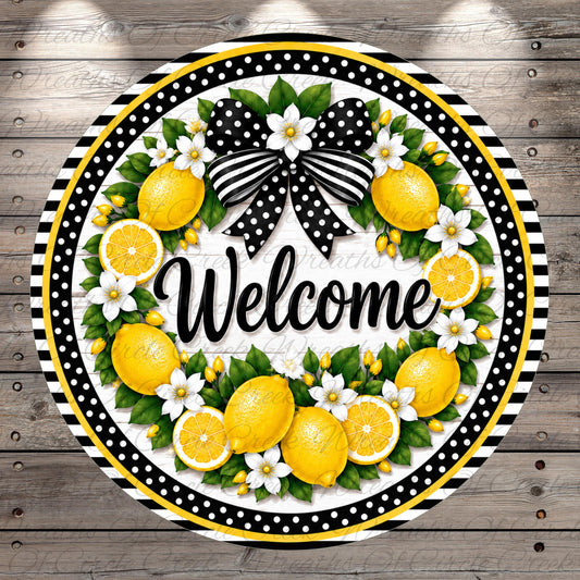 A decorative wreath with a black and white polka dot border, surrounded by yellow lemons, white flowers, and green leaves. The word "Welcome" is written in cursive on the wreath.