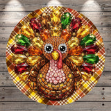 A colorful and intricate turban-like design made of various materials, including jewels, beads, and feathers, is displayed on a wooden surface.