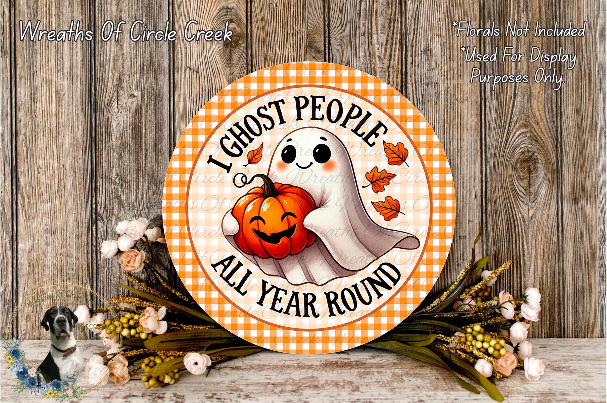 a Halloween-themed sign with a ghost holding a pumpkin, surrounded by flowers and a wooden background.