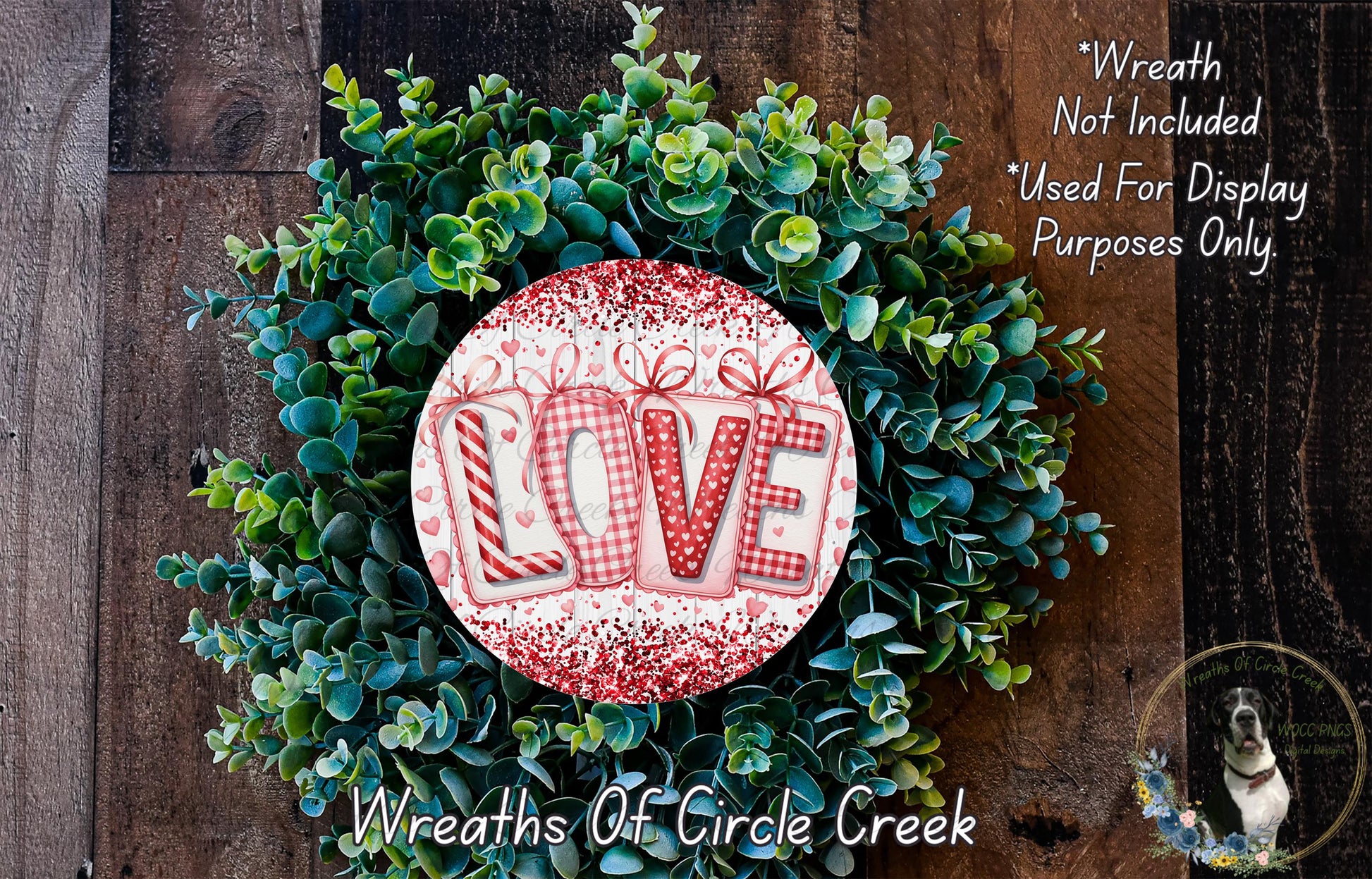 A wreath made of green leaves and a red and white circular sign with the word "LOVE" written on it.
