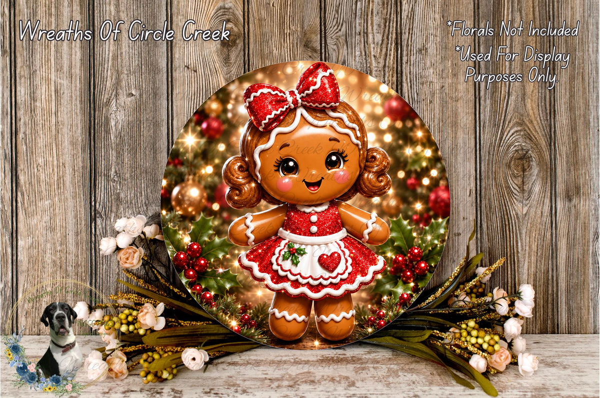 A round, decorative plate featuring a gingerbread girl with a bow, surrounded by a wreath of flowers and greenery, against a wooden background.