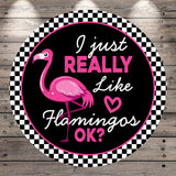 A circular sign with a pink flamingo and the text "I just really like flamingos" in pink and black.