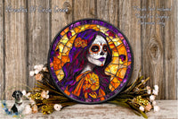 a colorful stained glass portrait of a woman with a skull-like face, surrounded by flowers and placed on a wooden surface.