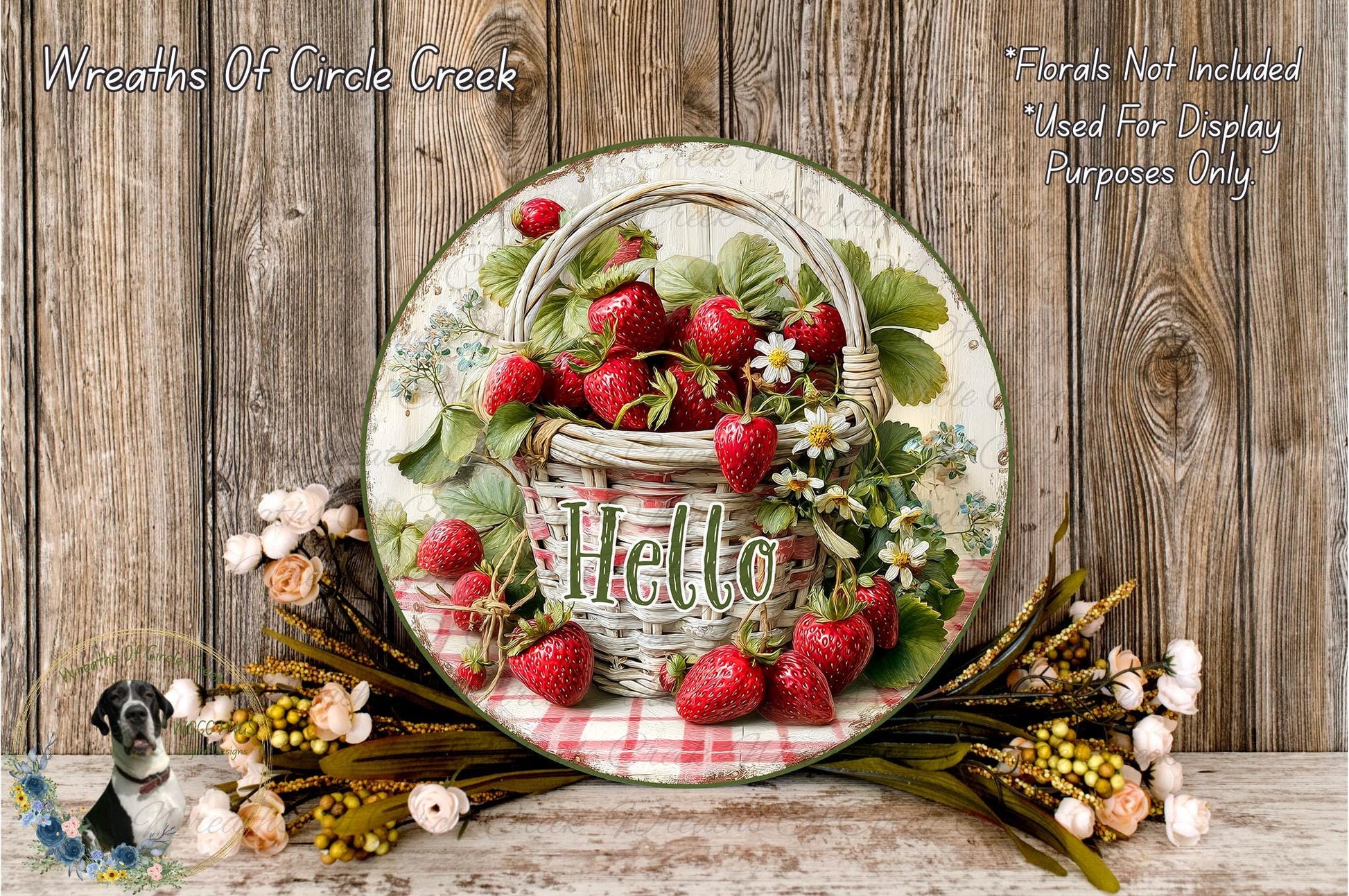 A decorative plate with a basket of fresh strawberries and flowers, including the word "Hello" written on it, placed on a wooden surface.