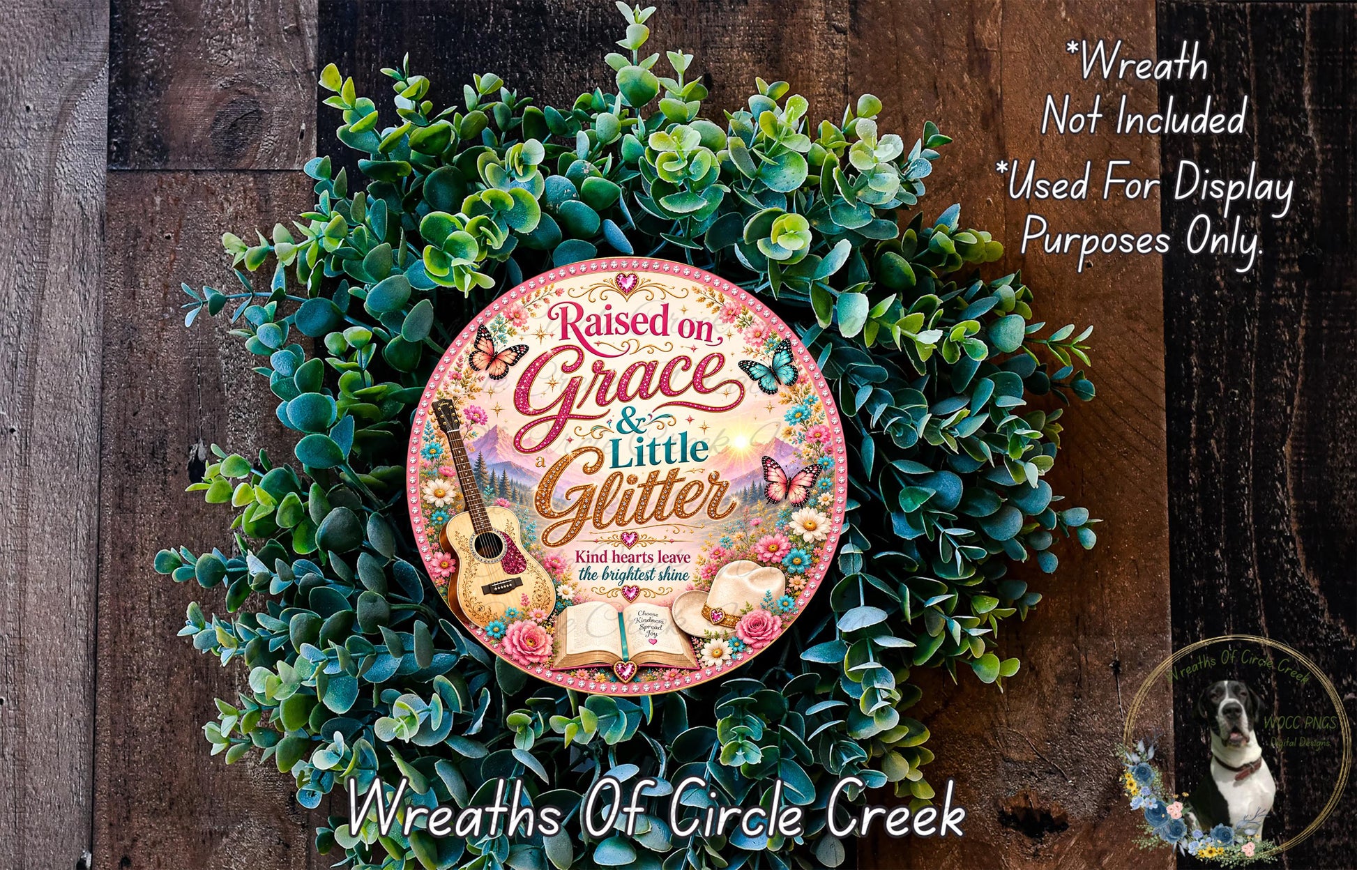 a wreath made of green leaves and flowers, with a large circular sign in the center that reads "Raised on Grace & Little Glitter".