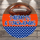 A football is displayed on a wooden surface, with the text "tailgates & touchdowns" written in a playful, casual font.