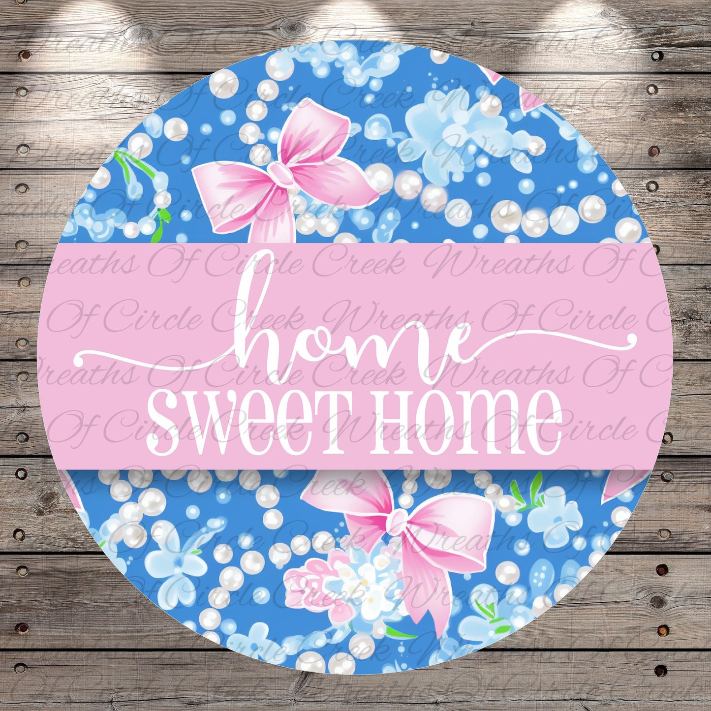 The image is a circular design with a floral pattern and pink bows. The text "home sweet home" is written in a cursive font on the design.