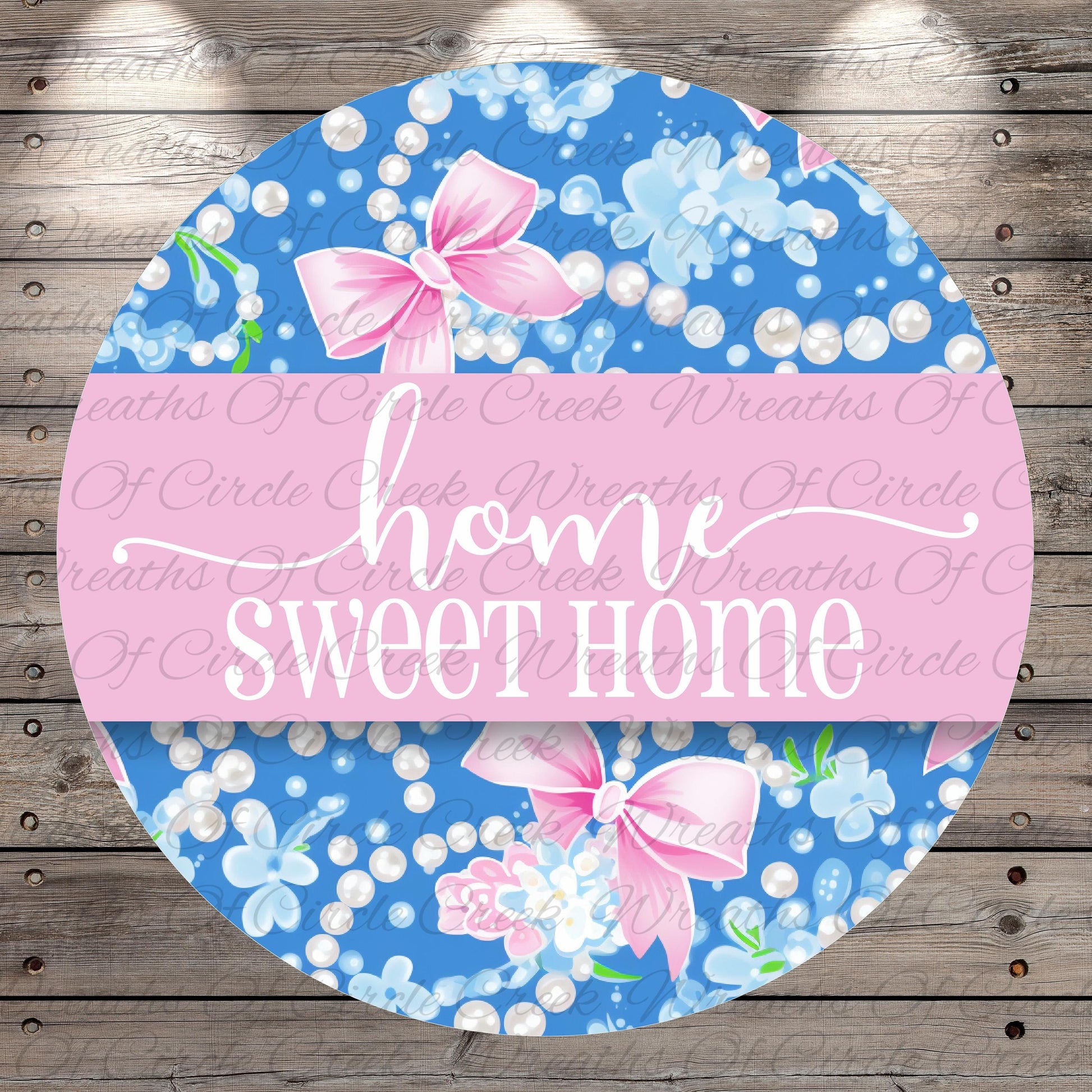 The image is a circular design with a floral pattern and pink bows. The text "home sweet home" is written in a cursive font on the design.