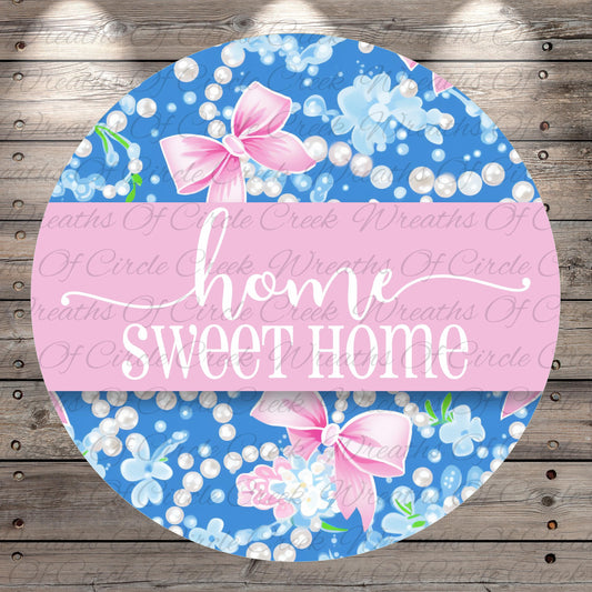 The image is a circular design with a floral pattern and pink bows. The text "home sweet home" is written in a cursive font on the design.