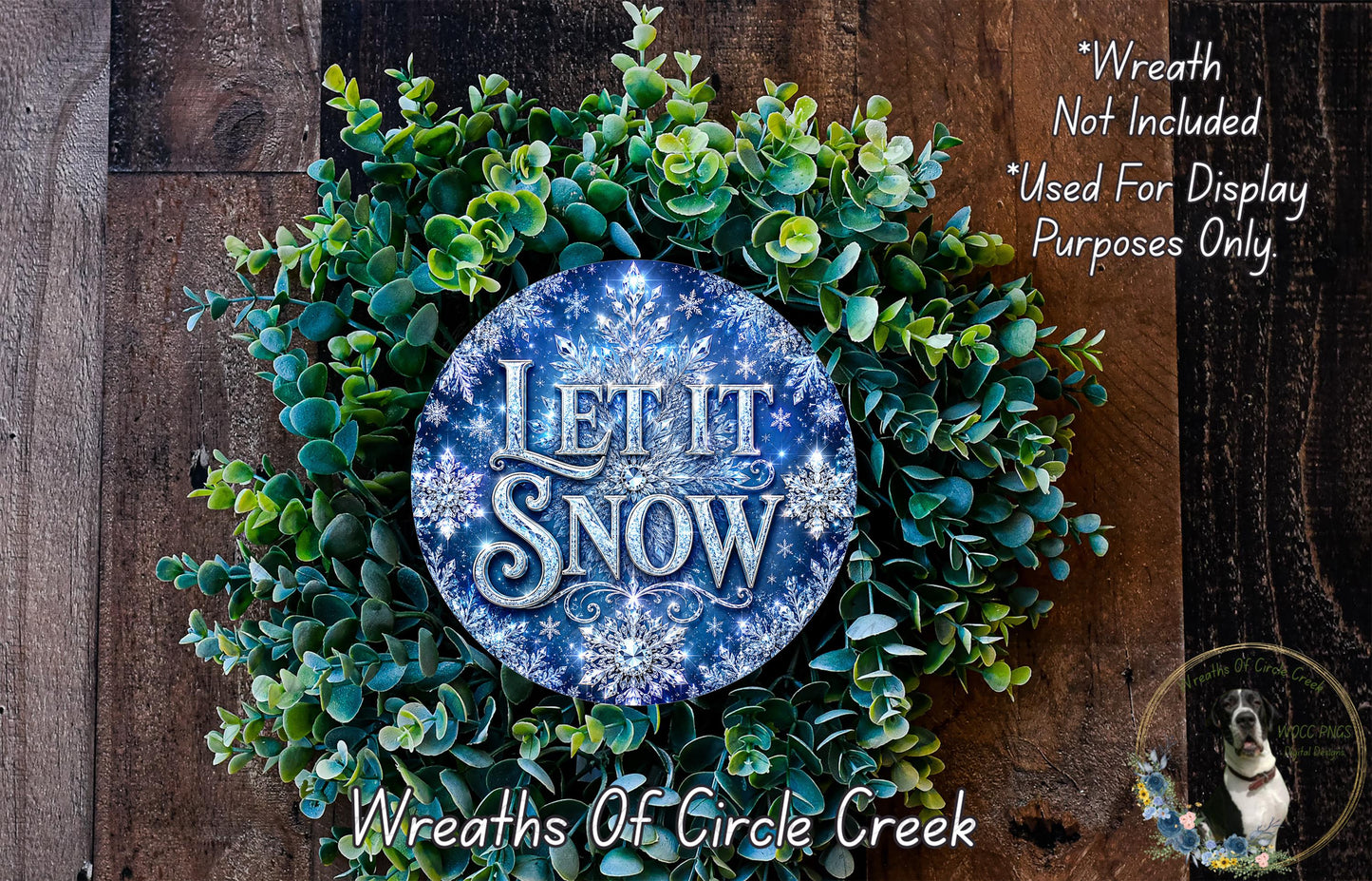 A wreath made of green leaves and branches, with a blue circular sign that says "Let it snow" in the center.
