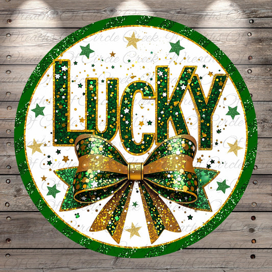 a circular design with the word "Lucky" prominently displayed in the center, surrounded by a green and gold bow and a scattering of stars.