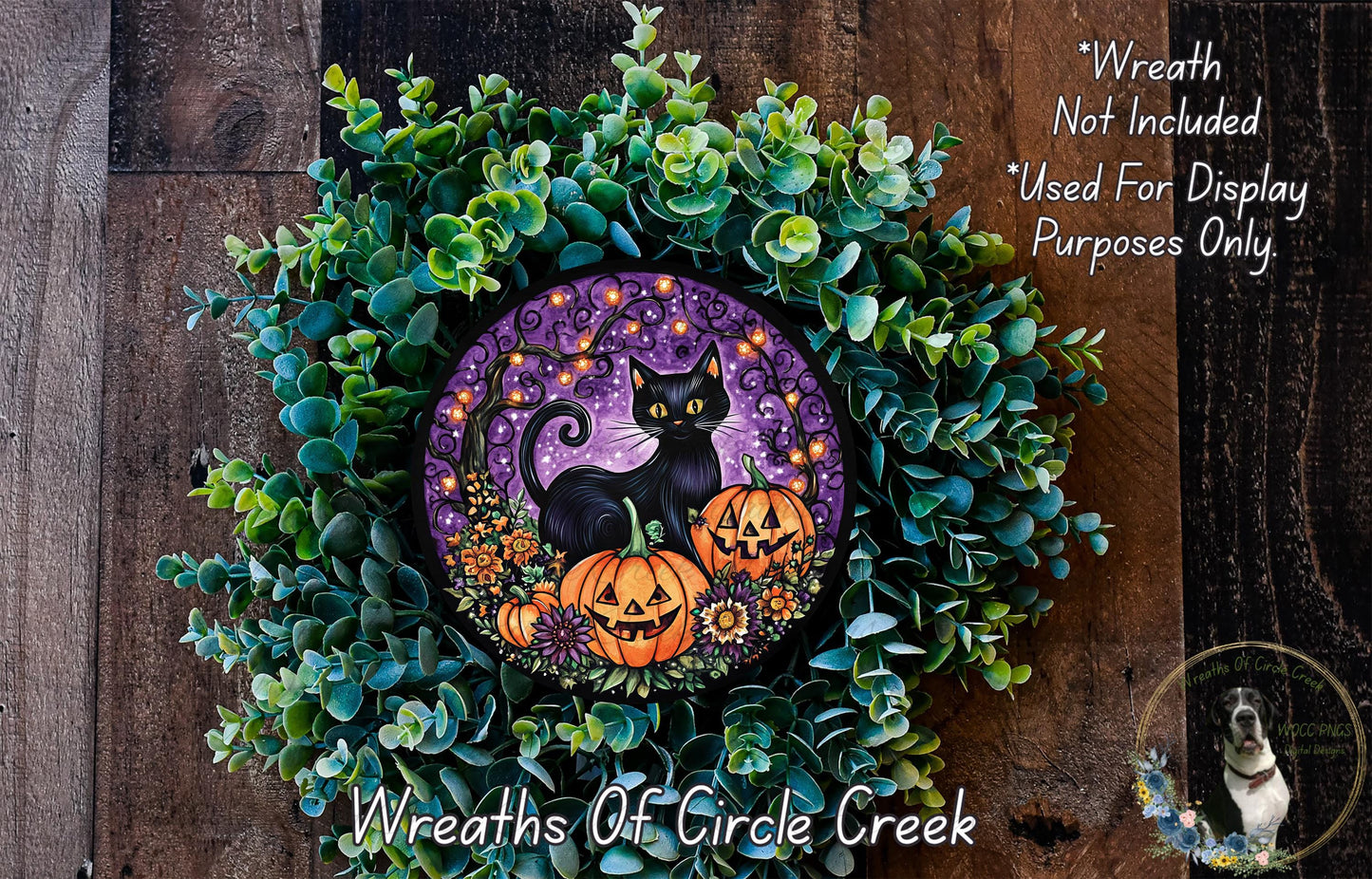 A Halloween-themed wreath made of green foliage and featuring a black cat, pumpkins, and a purple background.